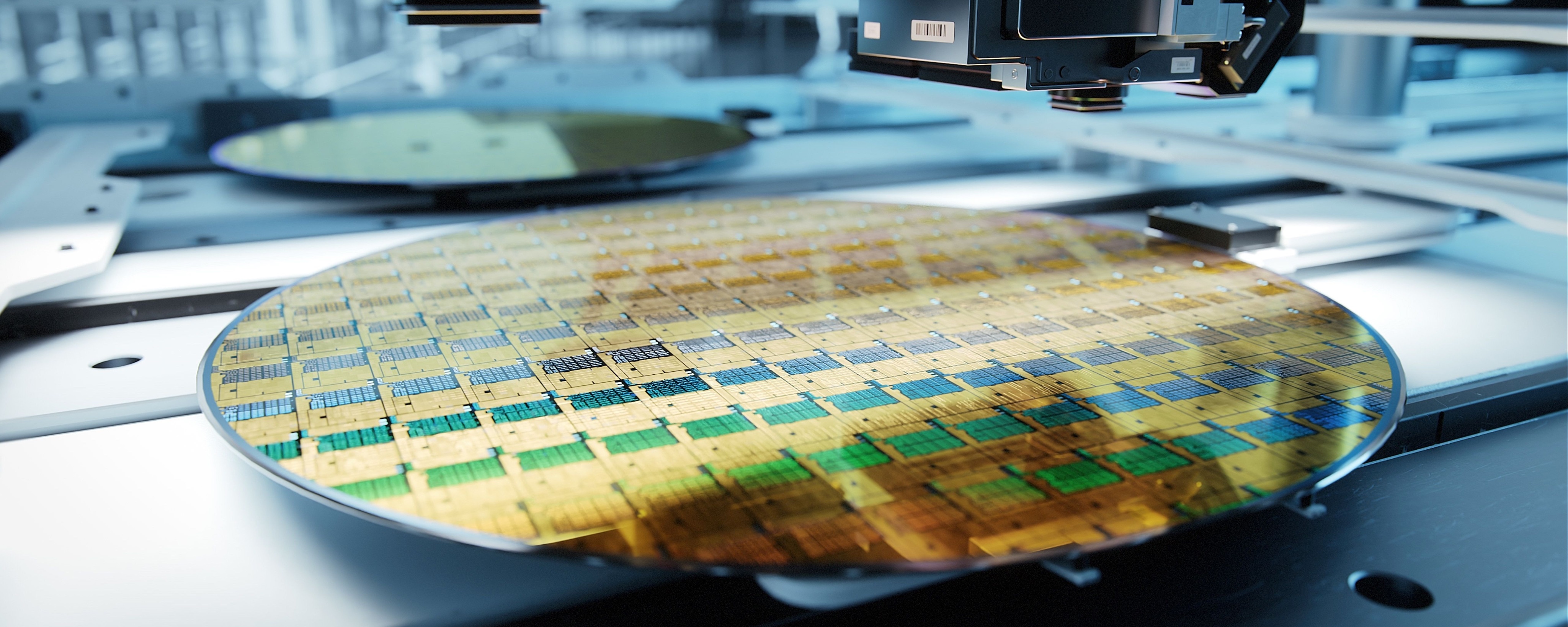A silicon wafer beneath semiconductor manufacturing equipment.